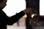 woman lighting lamps